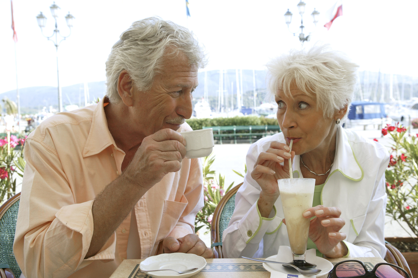 Senior couple enjoy a cup of cappuccino and ice cream parlor in summer holidays